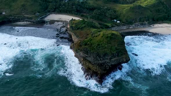 Giant volcanic rock between paradise beaches on Kasap coast, Java, Indonesia, aerial alt