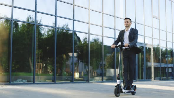 Businessman Riding an Electric Scooter for a Business Meeting in the Office