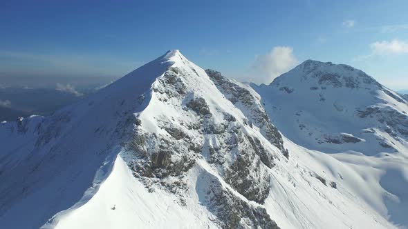 Aerial Along Snowcovered Mountain Ridge