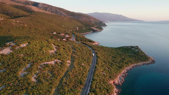 Aerial View Landscape Rocky Coast of Croatia with Curvy Mountain Road at Sunset alt