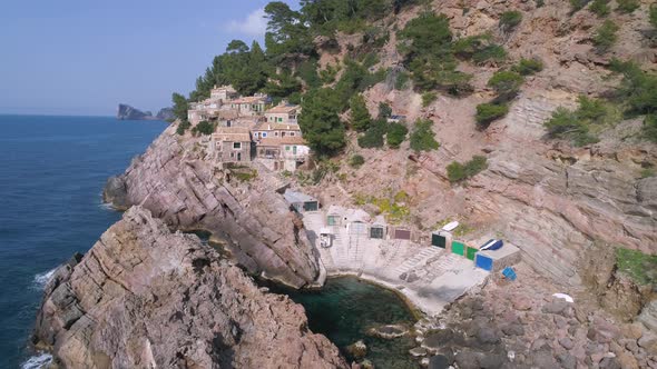 Ancient town on rocky coast near sea alt