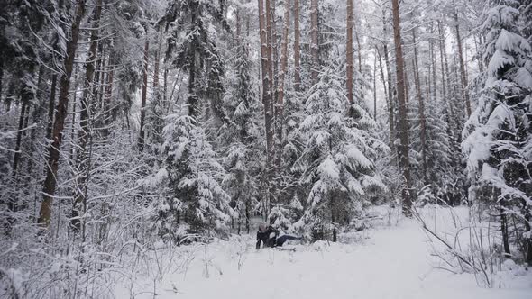 Man in a Jacket Runs in Winter Forest Slips Falls and Snow Falls on Him alt