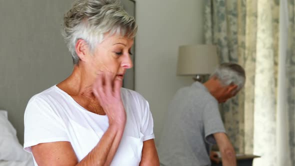 Upset senior couple arguing with each other in bedroom alt