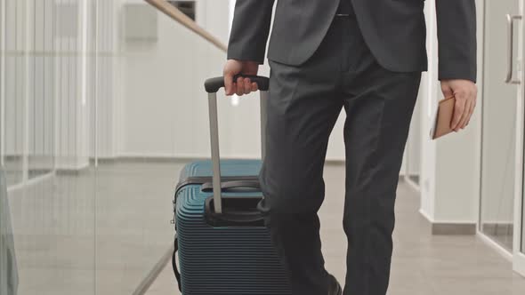 Portrait of Businessman with Suitcase in Airport alt
