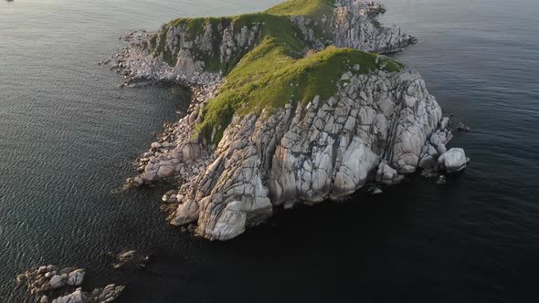 Rocky Islands in Triozerye Bay at Sunset alt