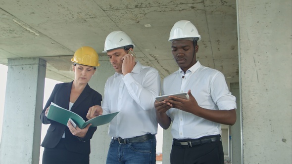 Group of Engineers and Experts Discuss About Construction Site