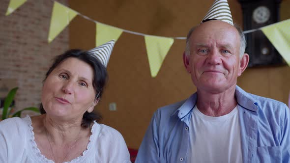 Birthday Online, Elderly Couple an Old Man and Woman in Holiday Caps Congratulate Their Family or