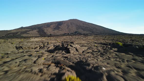 Aerial view of the "Piton de la Fournaise" volcano. Grazing view of the dry lava flows, we discover alt