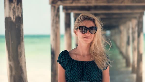 Woman Smiling And Relaxing On Beach.  Stress Free Girl In Summertime Season Sundress Leisure. alt