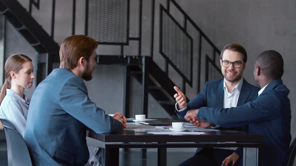 Startup young team meeting at the work site to discuss alt