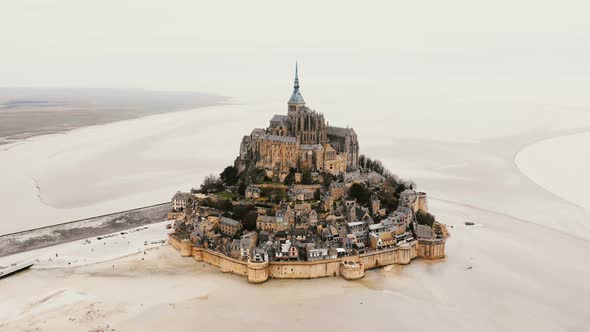 Drone Zooming in on Mont Saint Michel Abbey, Epic Island Fortress Town and Famous Travel Landmark in alt