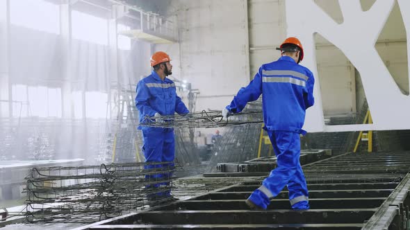 Factory workers bringing armature at manufacture