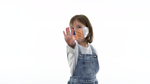 On the child a protective medical mask with flag of USA.