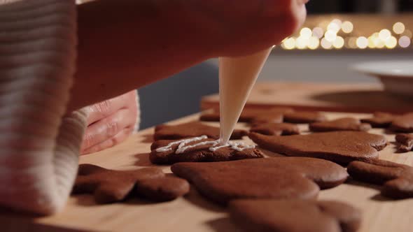 Close Up of Woman Decorating Gingerbread at Home