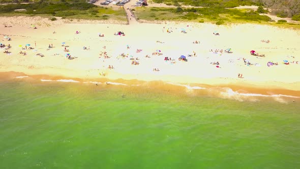 Aerial backward of tourists on white beach, Burlingame Park. Charlestown alt
