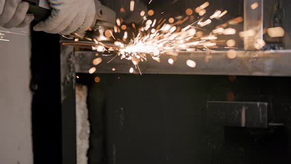 Manual Cleaning of Welded Seams with an Angle Grinder with a Flap Disc on Welded Metal Construction
