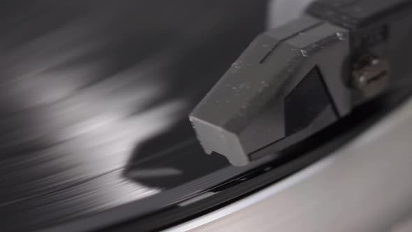 Vinyl Record Is Spinning On A Turntable With Arm And Needle alt