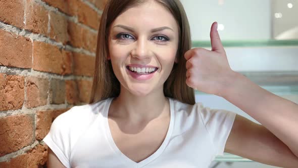 Thumbs Up By Young Woman Positive Gesture at Home alt