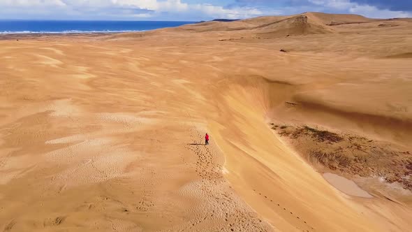 Walking on sand dunes in New Zealand alt