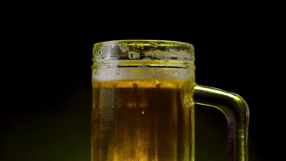 Light Beer Rotates on a Black Background