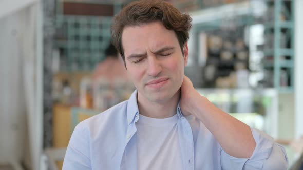 Portrait of Young Man Having Neck Pain alt