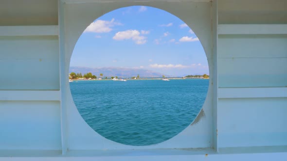City Summer Landscape View of Greece Seen From Inside a Ship Cabin with Round Peep-hole Window