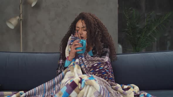 Sick Woman Suffering From Flu Sneezing on Couch alt