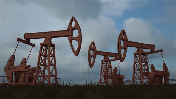 Oil worker standing among the oil pump jacks