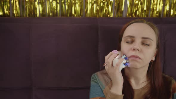A Woman with Problematic Skin Using Face Electric Massager alt