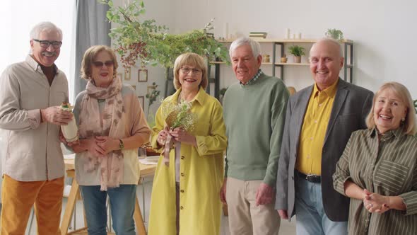 Portrait of Cheerful Senior Friends at Home alt