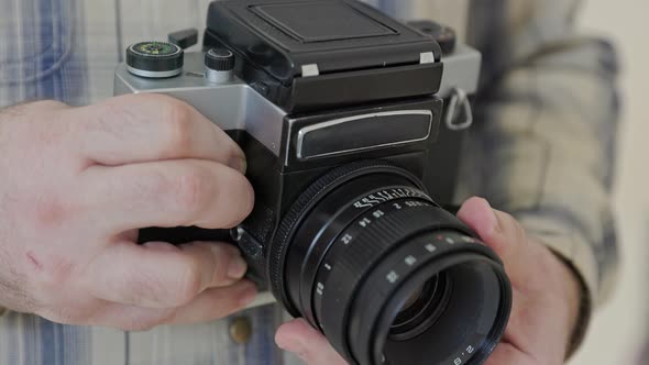 Close-up vintage photo camera details, setting up the film camera. alt