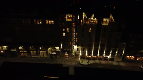 Drone View at Night of Illuminated Houses on a Street in Edinburgh
