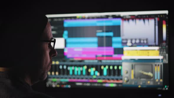 An Experienced Sound Engineer Mixes a Music Track in His Home Studio alt