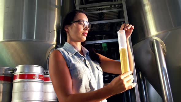 Female brewer testing beer 4k alt
