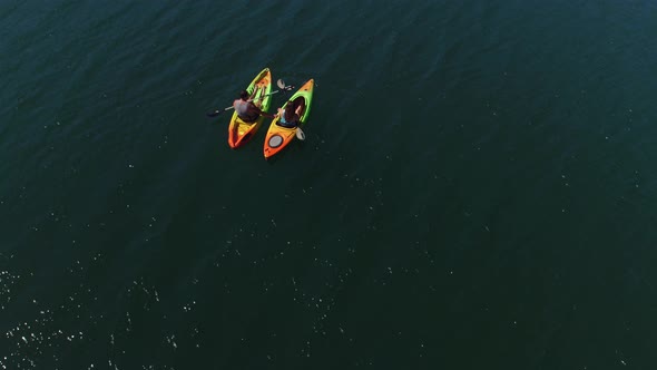 Aerial drone shot of couple kayaking on lake