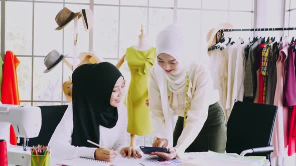 Muslim women fashion designers are in process of creating new clothes collection. alt