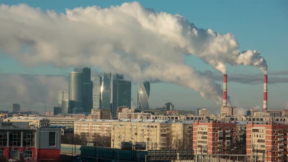 View of Moscow City With Smoke Goes from Tubes of Power Plant in cold day at winter.