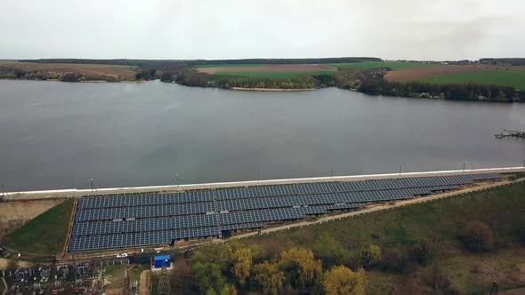 Aerial view of Solar panels near the river. Alternative source of electricity. Solar farm. alt