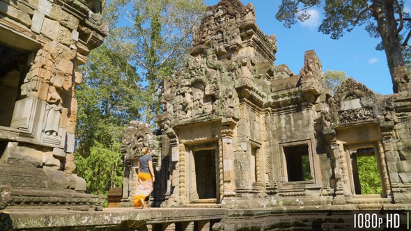 Young Woman Walking on Ancient Ruins Near Angkor Wat in Cambodia alt