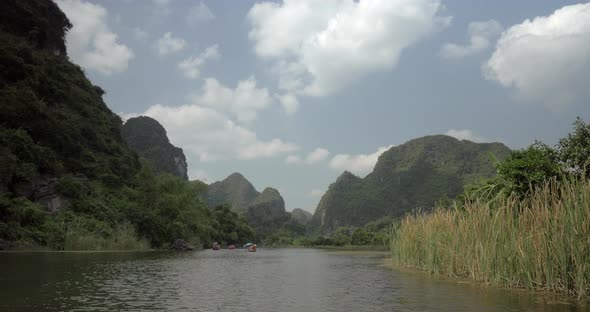 Trang an Bai in Hanoi, Vietnam on a Scenic River Sailing Boat with Tourists alt