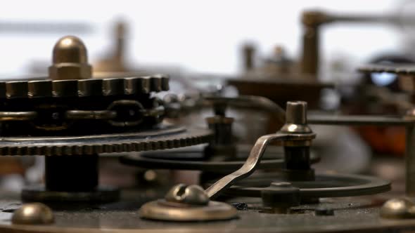 A Complex Mechanism with Many Rotating Gears, Chain, Piston, Cogs. Very Similar To a Clock Mechanism alt