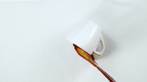 Super Slow Motion Shot of Spilling Coffee on White Cloth at 1000Fps. alt
