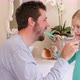 Smiling father and daughter helping each other to brush their teeth 4K 4k