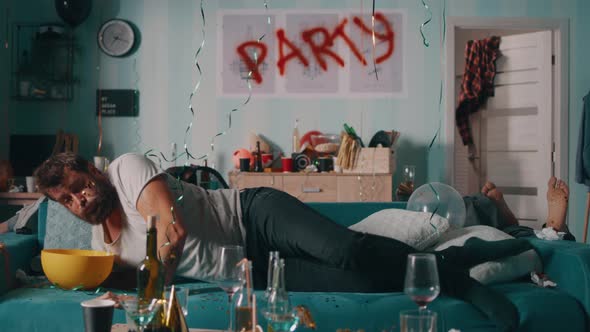 Drunk Man Waking Up on Sofa alt