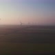 Windmills with rotating wings at sunrise or sunset or sunrise. - VideoHive Item for Sale