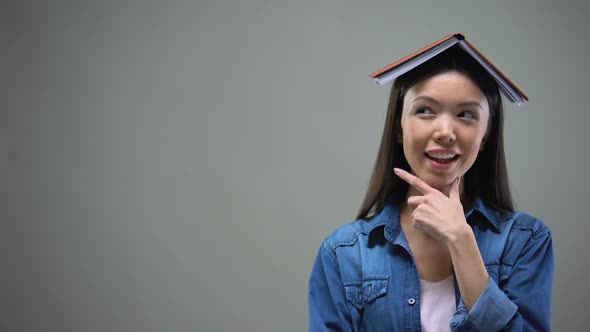 Clever Woman With Book on Head Thinking Over Ideas for New Startup, Calculations alt