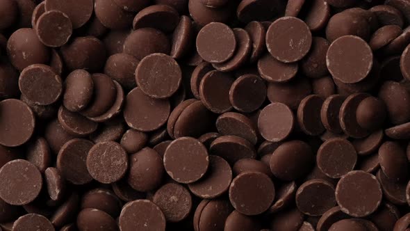 chocolate. milk chocolate chips top view rotation. confectionery concept alt