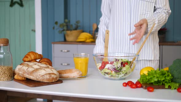Female Cooking Healthy Salad In The Kitchen. Closeup alt