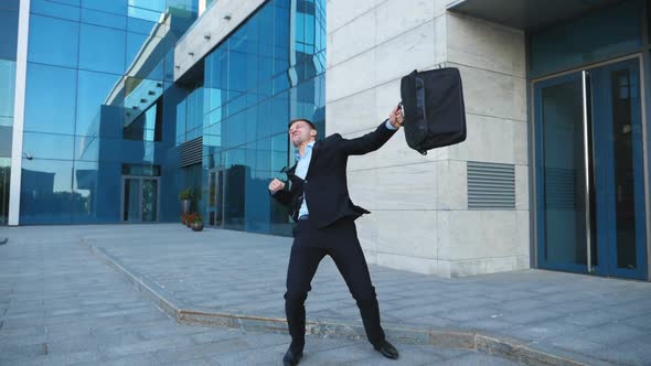 Young Happy Businessman in Suit Rejoices at Good Deal on City Street. Successful Office Worker alt