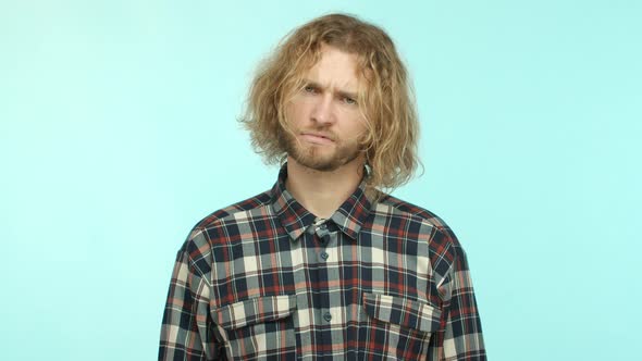 Slow Motion of Puzzled Blond Guy with Wavy Long Hair Cant Understand Something Frowning and Looking